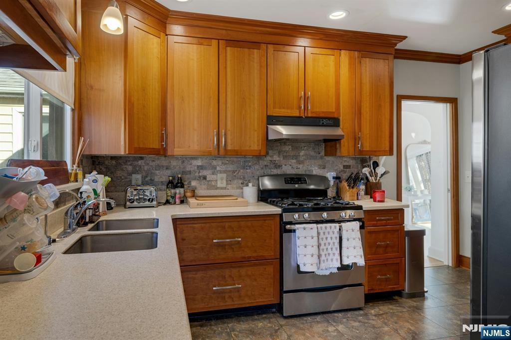 120 Meadowbrook Road Livingston, NJ 07039 - Photo 12 of 36 a kitchen with a stove a sink and a refrigerator