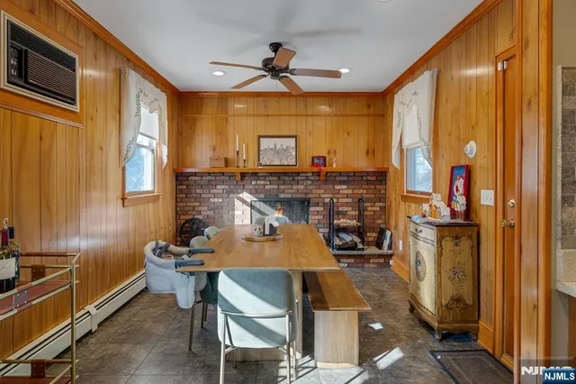 a room with chairs cabinets and flat screen tv