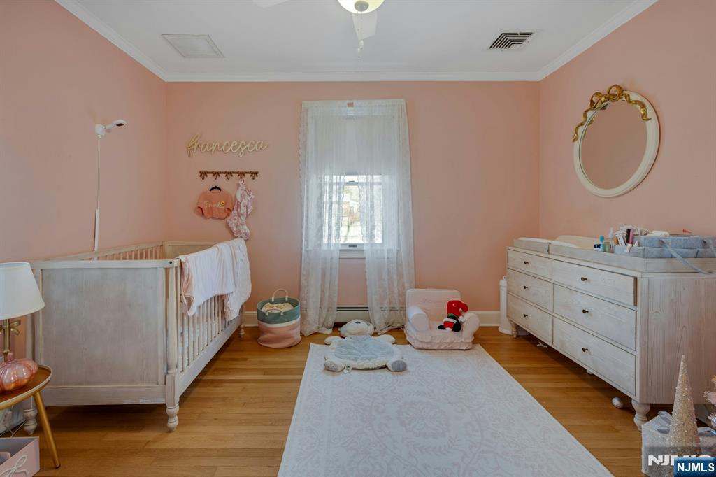 120 Meadowbrook Road Livingston, NJ 07039 - Photo 21 of 36 a bedroom with a baby bed dresser and a window