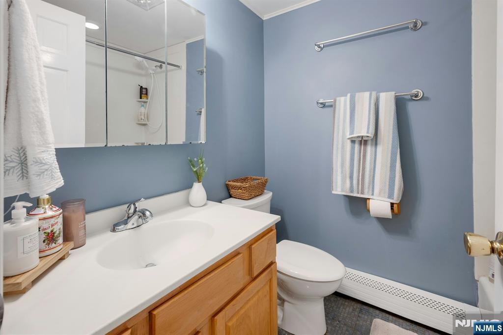 120 Meadowbrook Road Livingston, NJ 07039 - Photo 22 of 36 a bathroom with a sink toilet and mirror