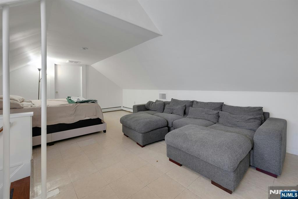 120 Meadowbrook Road Livingston, NJ 07039 - Photo 24 of 36 a living room with furniture and a lamp