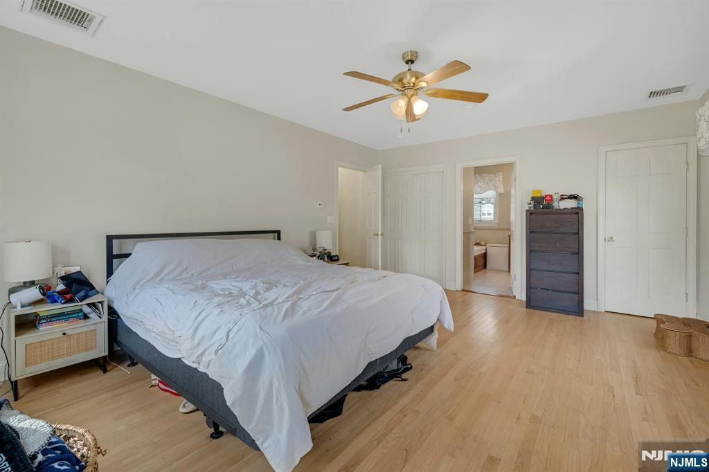 120 Meadowbrook Road Livingston, NJ 07039 - Photo 29 of 36 a spacious bedroom with a bed and a chandelier