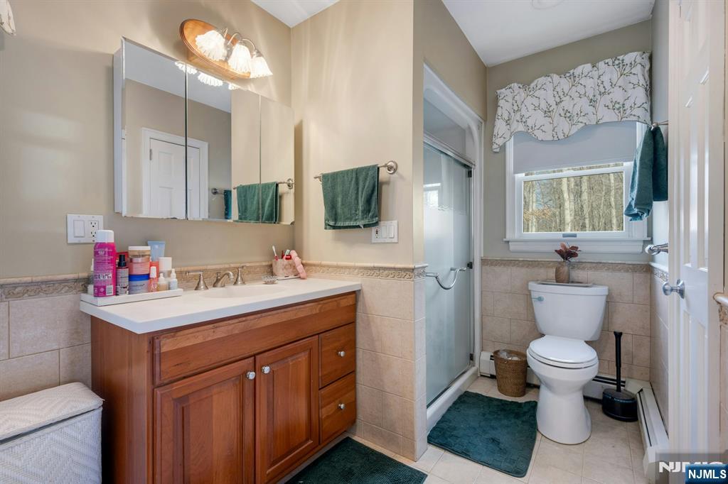 120 Meadowbrook Road Livingston, NJ 07039 - Photo 31 of 36 a bathroom with a sink vanity mirror and toilet