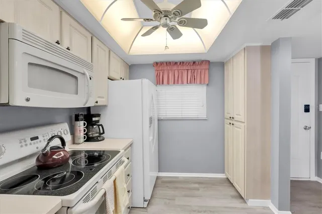 a kitchen with stainless steel appliances a refrigerator a sink and cabinets