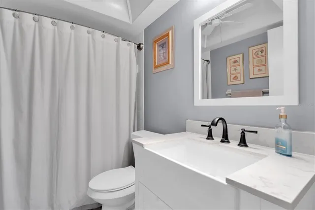 a bathroom with a toilet a sink and a mirror