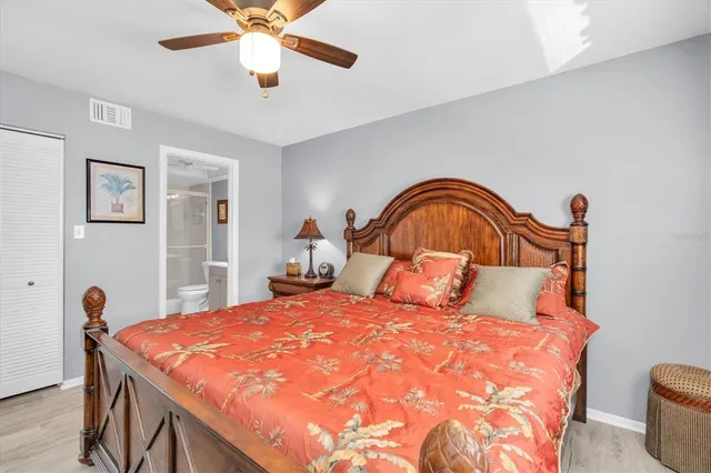 a bedroom with a bed and a ceiling fan