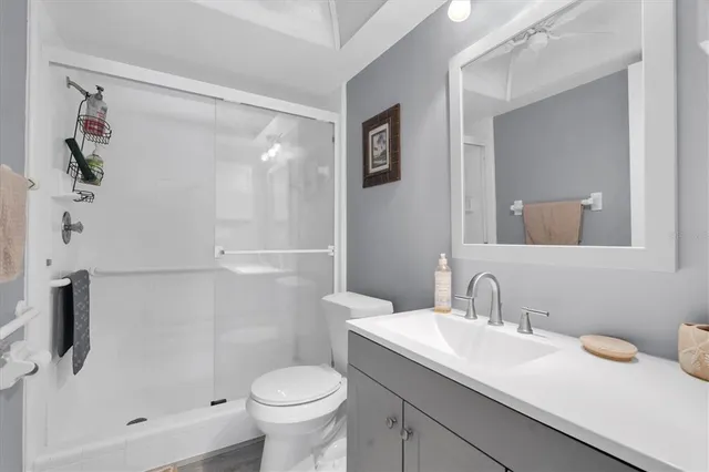 a bathroom with a sink toilet and shower