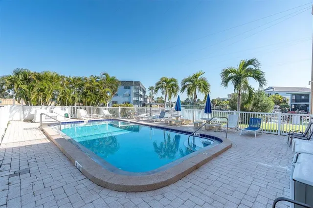 a view of swimming pool with outdoor seating and plants