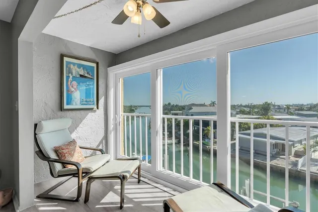 a view of a livingroom with furniture and a floor to ceiling window