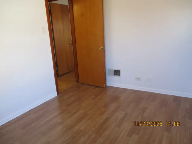 an empty room with wooden floor