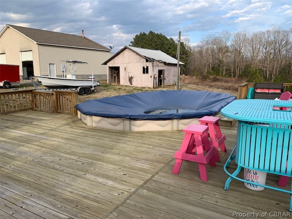 Above ground pool with large wrap around deck