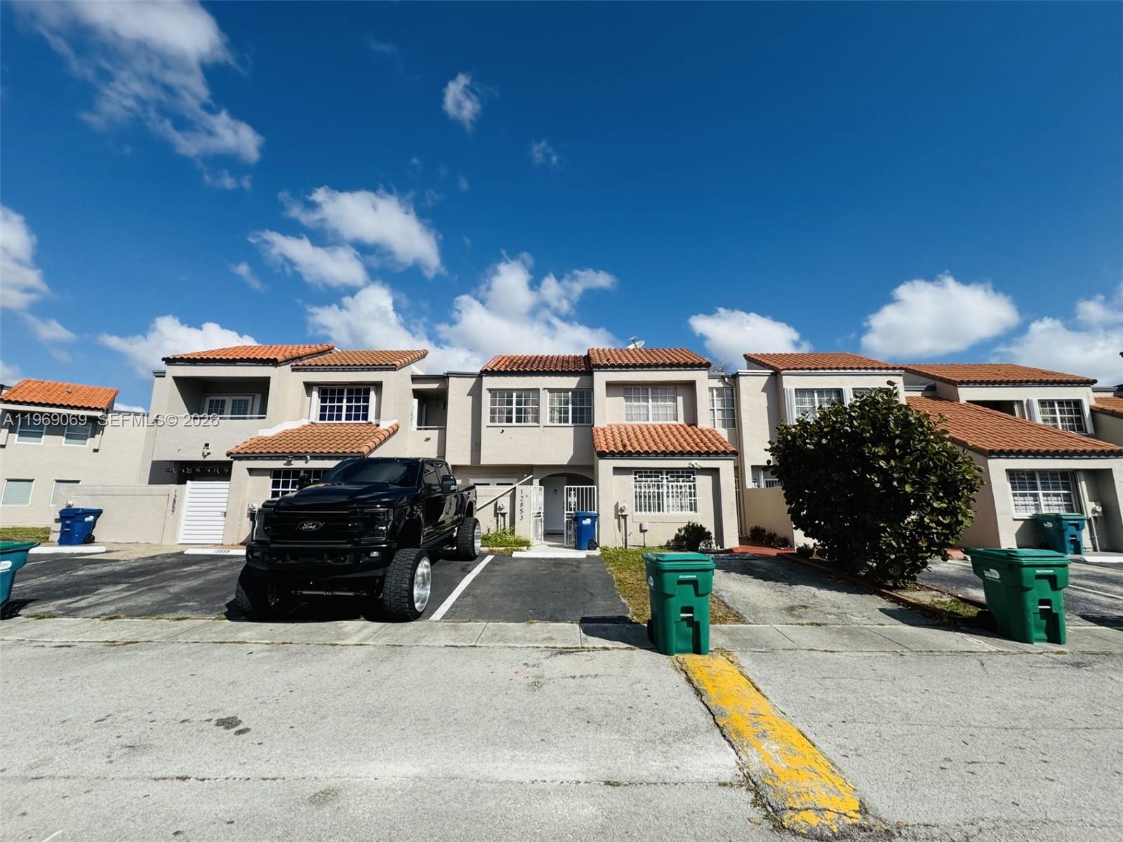 12853 Southwest 64th Lane Miami, FL 33183 - Photo 1 of 13 a front view of a house with a yard