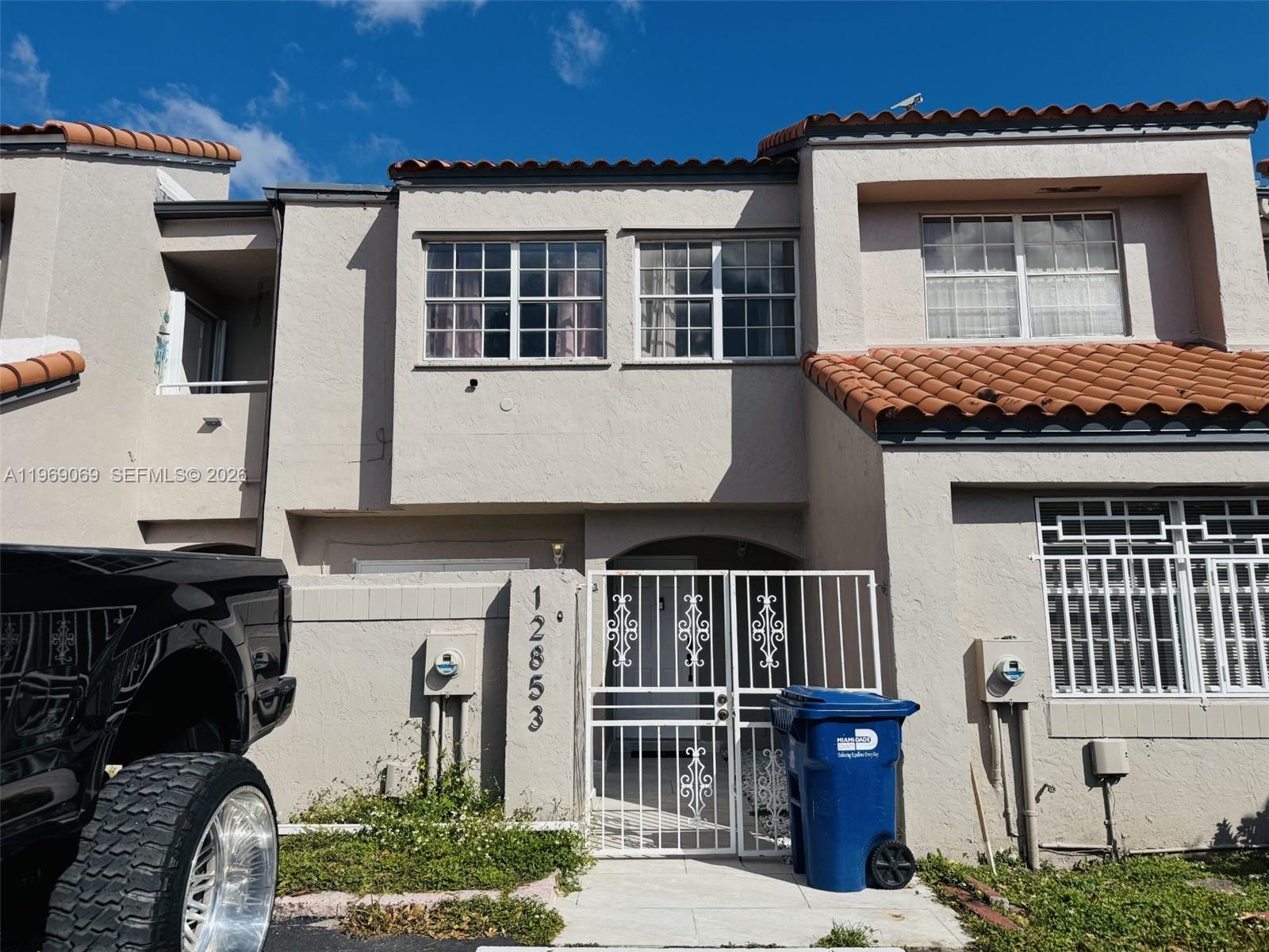 12853 Southwest 64th Lane Miami, FL 33183 - Photo 2 of 13 a front view of a house with a yard
