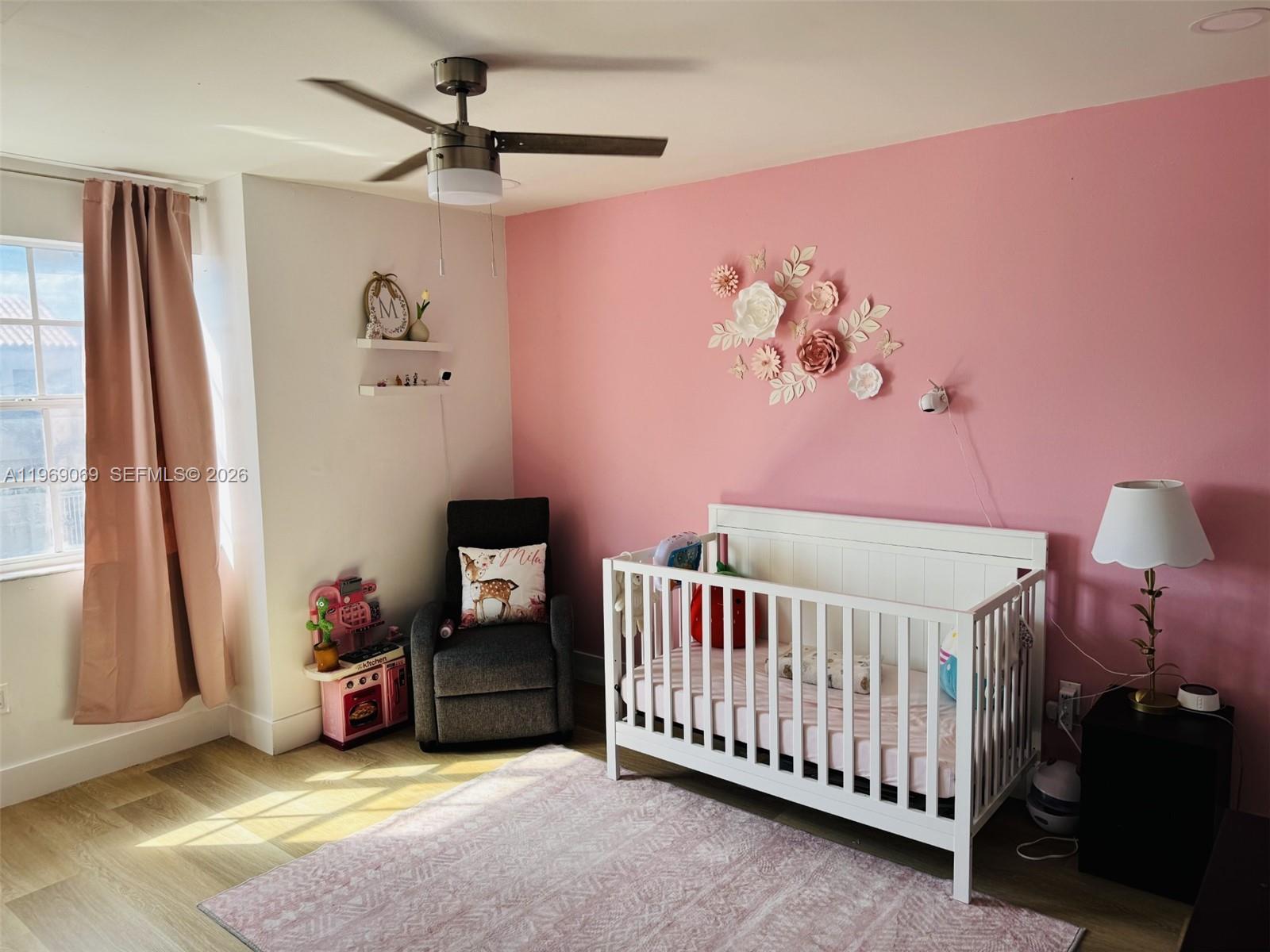 12853 Southwest 64th Lane Miami, FL 33183 - Photo 7 of 13 a bedroom with a bed and a chandelier