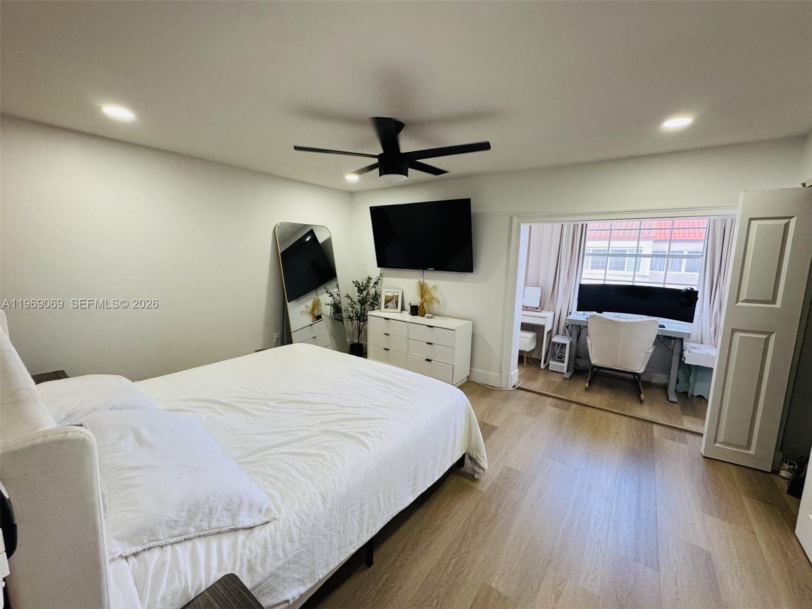 12853 Southwest 64th Lane Miami, FL 33183 - Photo 10 of 13 a bedroom with a bed and a flat screen tv