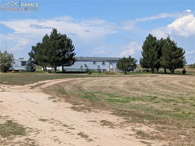 a view of a yard with a apartment building in the background