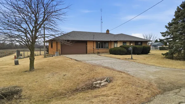 a front view of a building with a yard