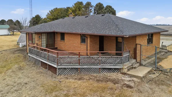 a view of house with a small yard and wooden fence