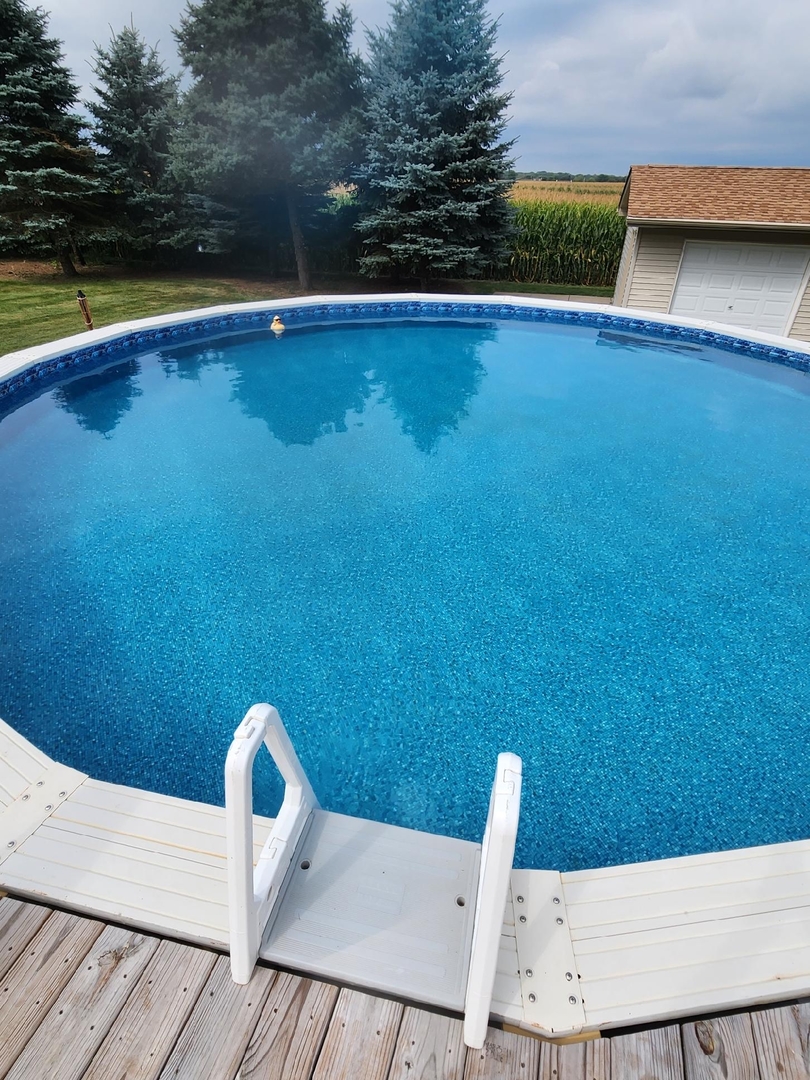2867 East 752nd Road Utica, IL 61373 - Photo 19 of 23 a view of a swimming pool with a yard