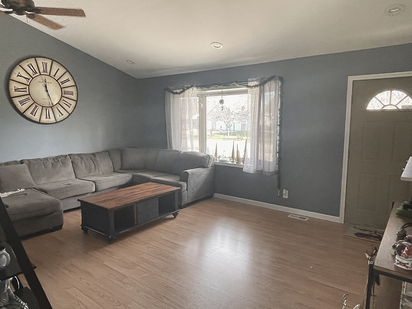 2867 East 752nd Road Utica, IL 61373 - Photo 3 of 23 a living room with furniture a clock and a window