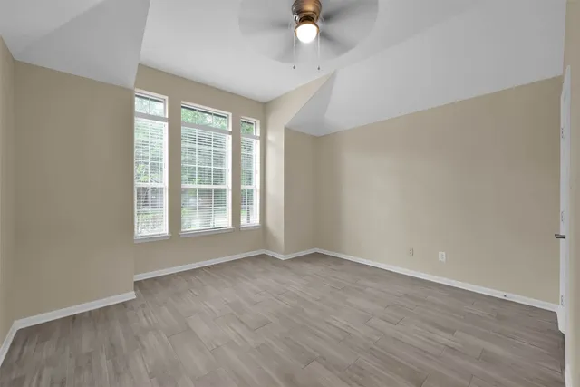 wooden floor in an empty room with a window