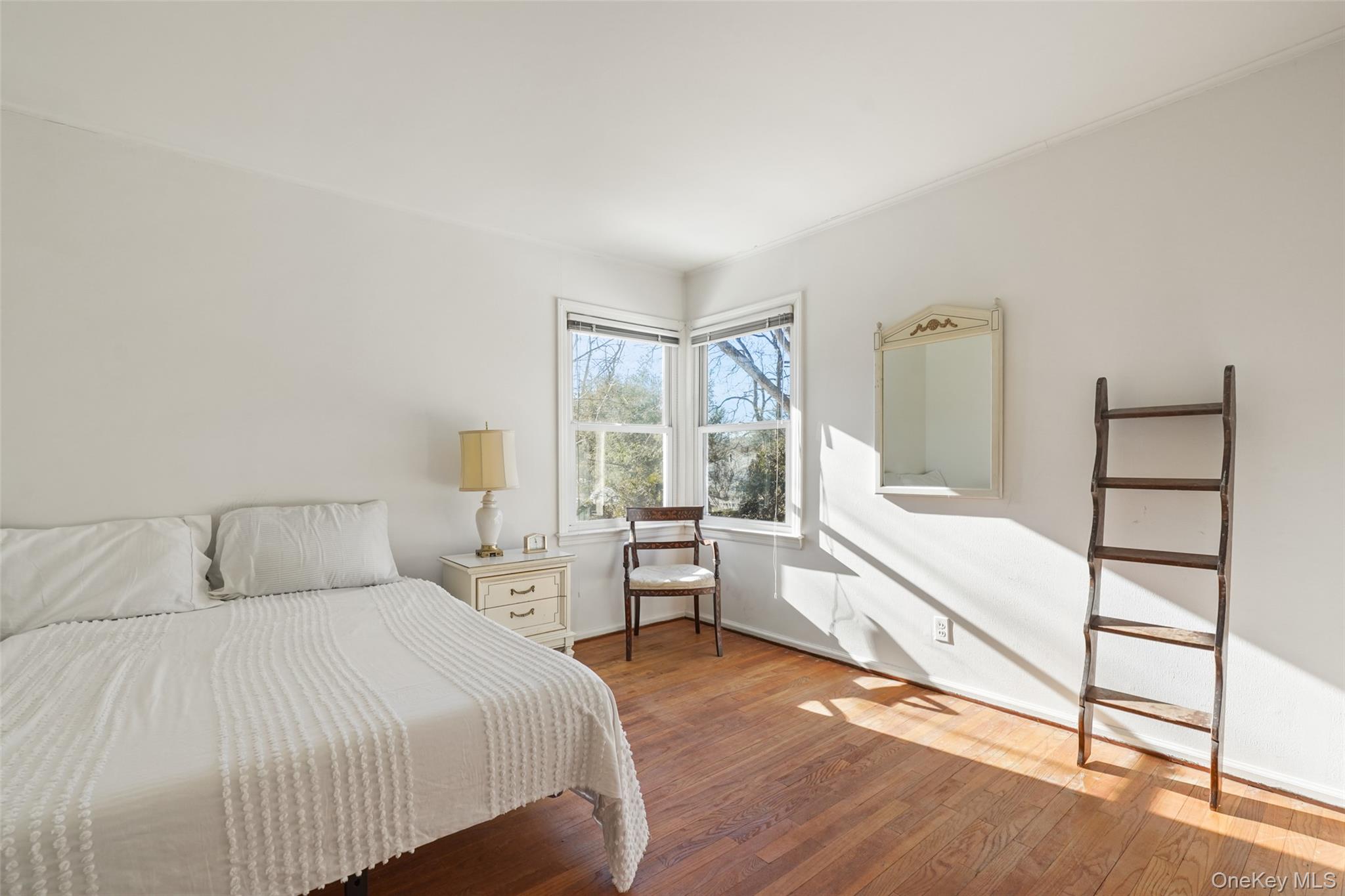 2 Churchill Road Rye Brook, NY 10573 - Photo 13 of 22 a spacious bedroom with a bed and a window