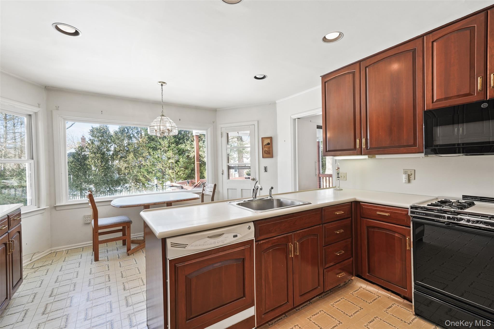 2 Churchill Road Rye Brook, NY 10573 - Photo 9 of 22 a kitchen with a sink stove and microwave