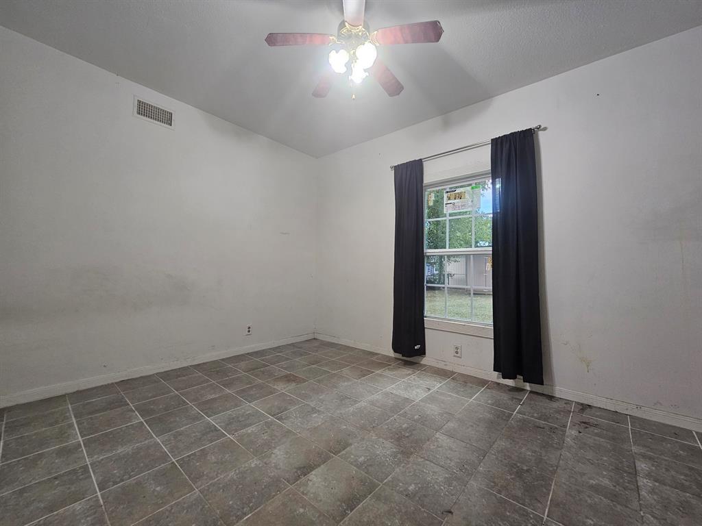 231 Elm Street Hurst, TX 76053 - Photo 9 of 11 an empty room with a empty space and windows