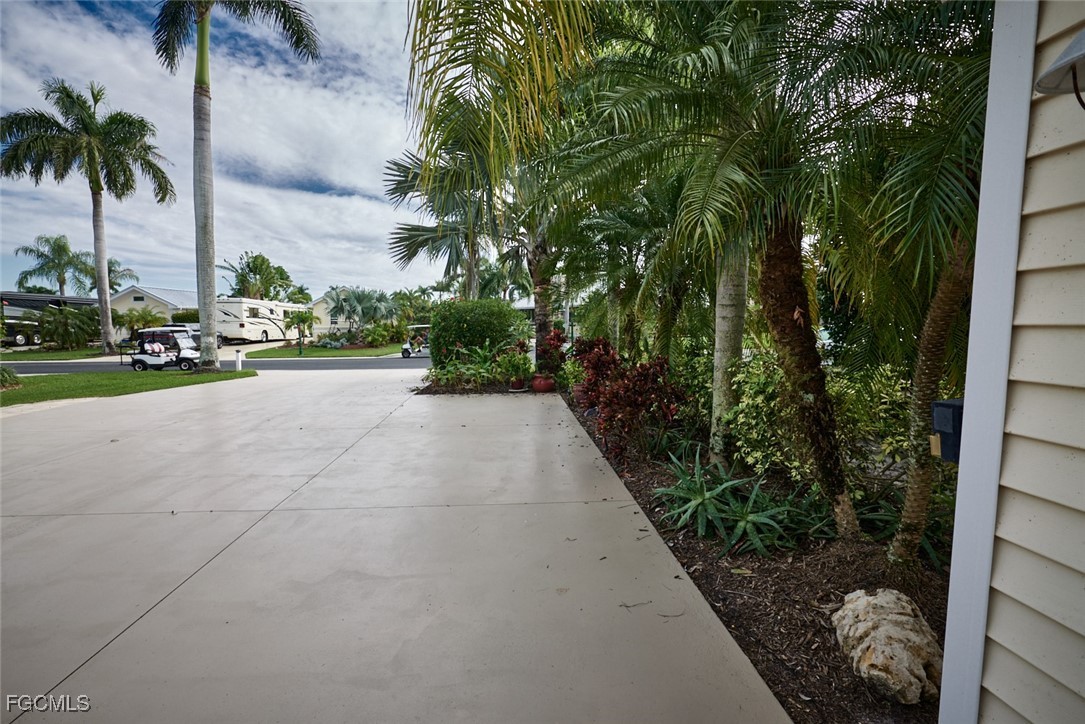 Lot 33-3003 West Riverbend Resort Boulevard LaBelle, FL 33935 - Photo 8 of 19 a view of a yard with potted plants and palm trees