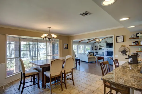 a kitchen with lots of counter top space and furniture