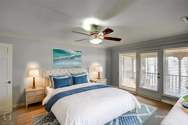 a bedroom with a bed a window and a chandelier