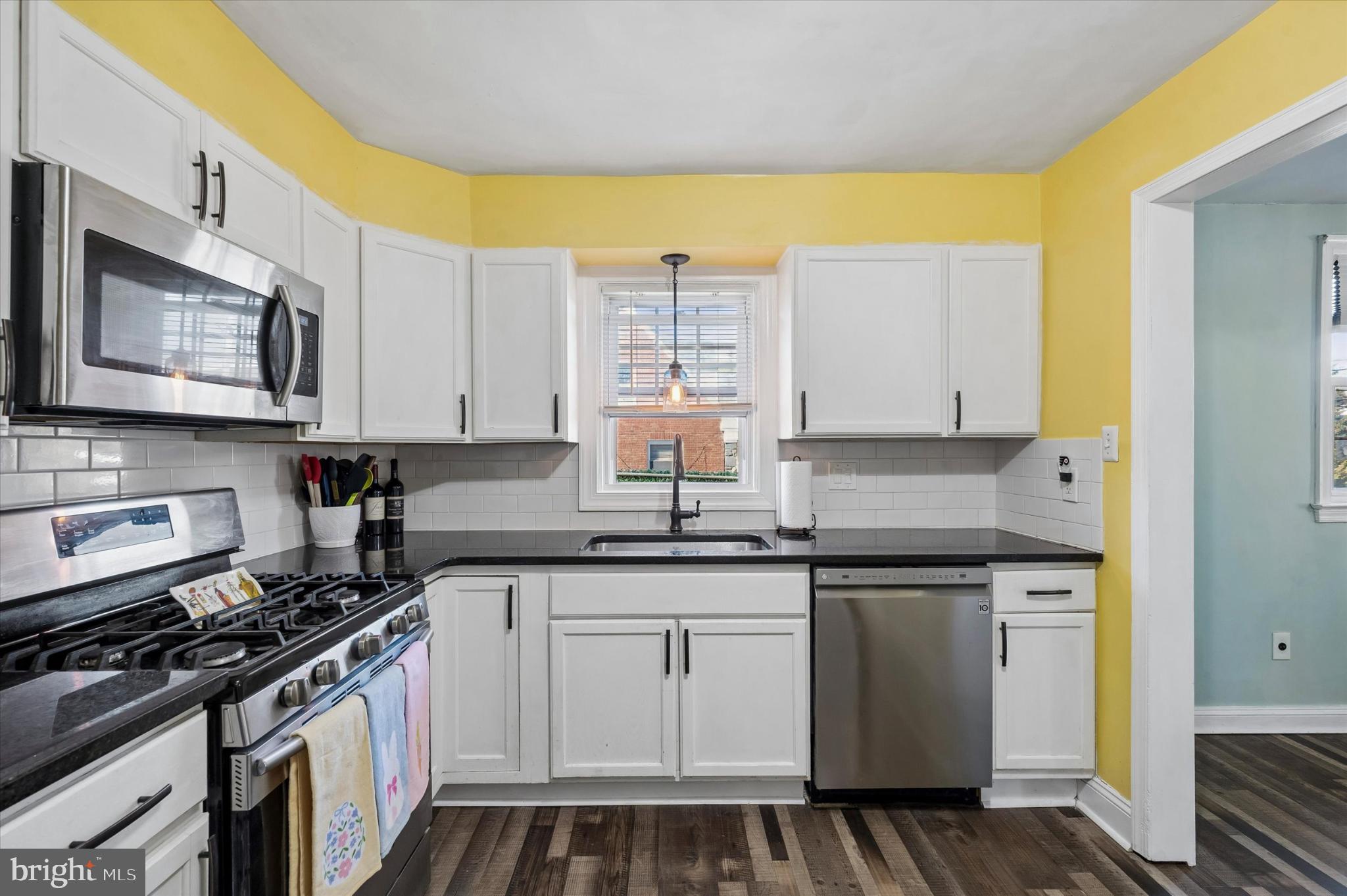 114 Providence Road Morton, PA 19070 - Photo 12 of 25 a kitchen with stainless steel appliances granite countertop a stove a sink and a microwave