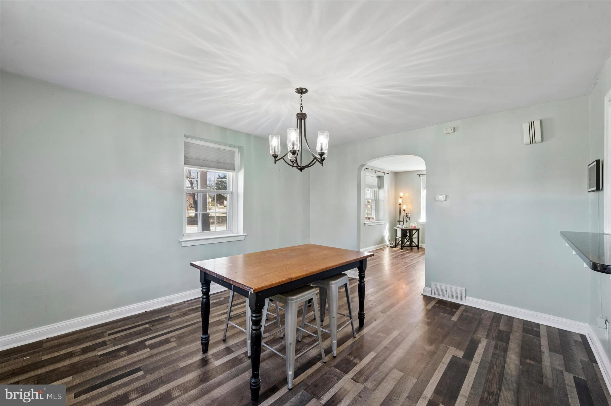 114 Providence Road Morton, PA 19070 - Photo 7 of 25 a view of a dining room with furniture a chandelier and wooden floor