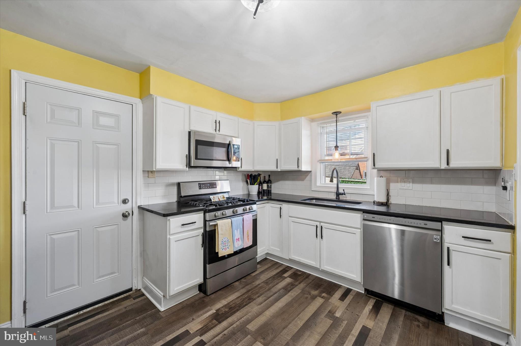 114 Providence Road Morton, PA 19070 - Photo 10 of 25 a kitchen with stainless steel appliances granite countertop a stove a sink and a white cabinets