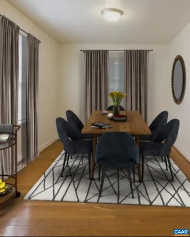 a dining room with furniture and wooden floor