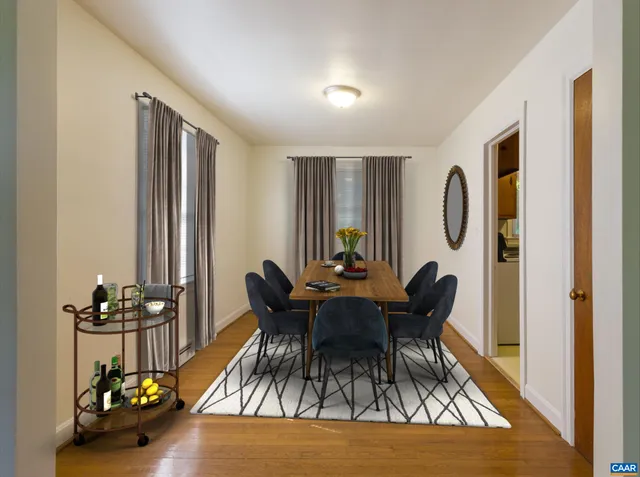 a view of a dining room with furniture and chandelier