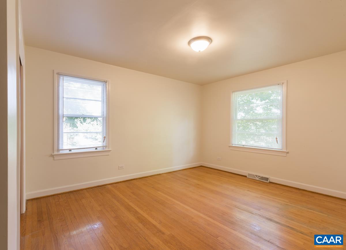 821 Cabell Avenue, Unit A&B Charlottesville, VA 22903 - Photo 9 of 27 an empty room with wooden floor and windows