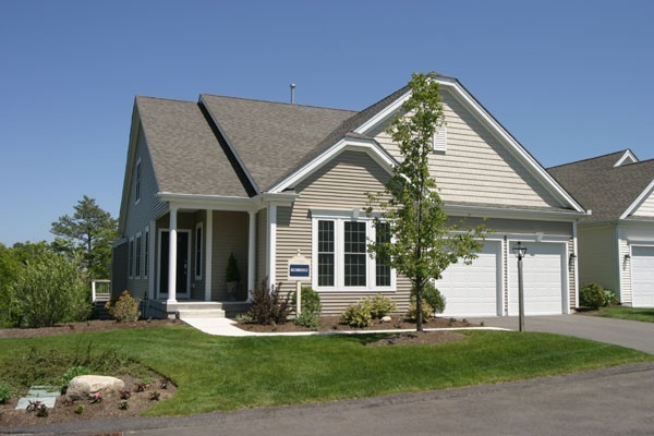 a front view of a house with a yard and porch