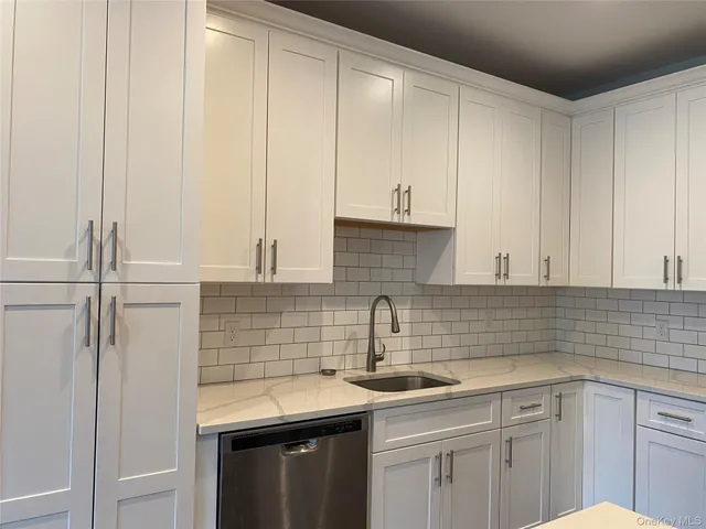 a kitchen with a sink cabinets and appliances