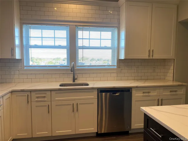 a kitchen with a sink a cabinets and window