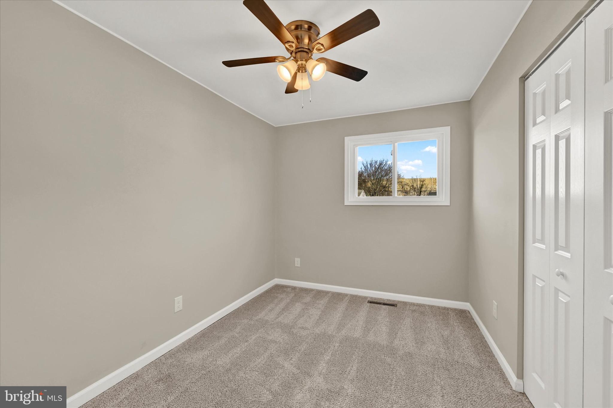8117 Callo Lane Rosedale, MD 21237 - Photo 12 of 23 an empty room with window and a ceiling fan