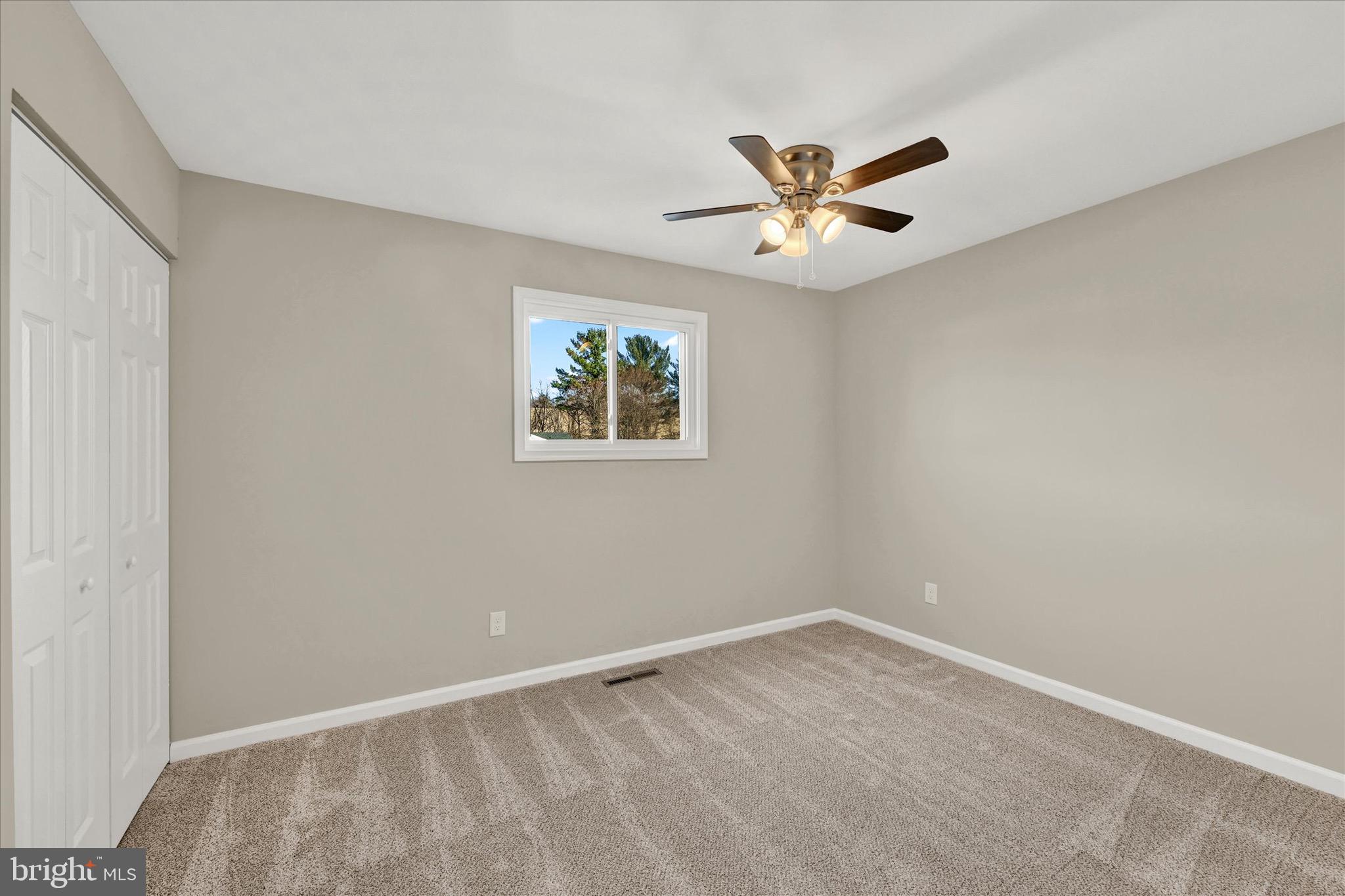 8117 Callo Lane Rosedale, MD 21237 - Photo 13 of 23 an empty room with windows and fan
