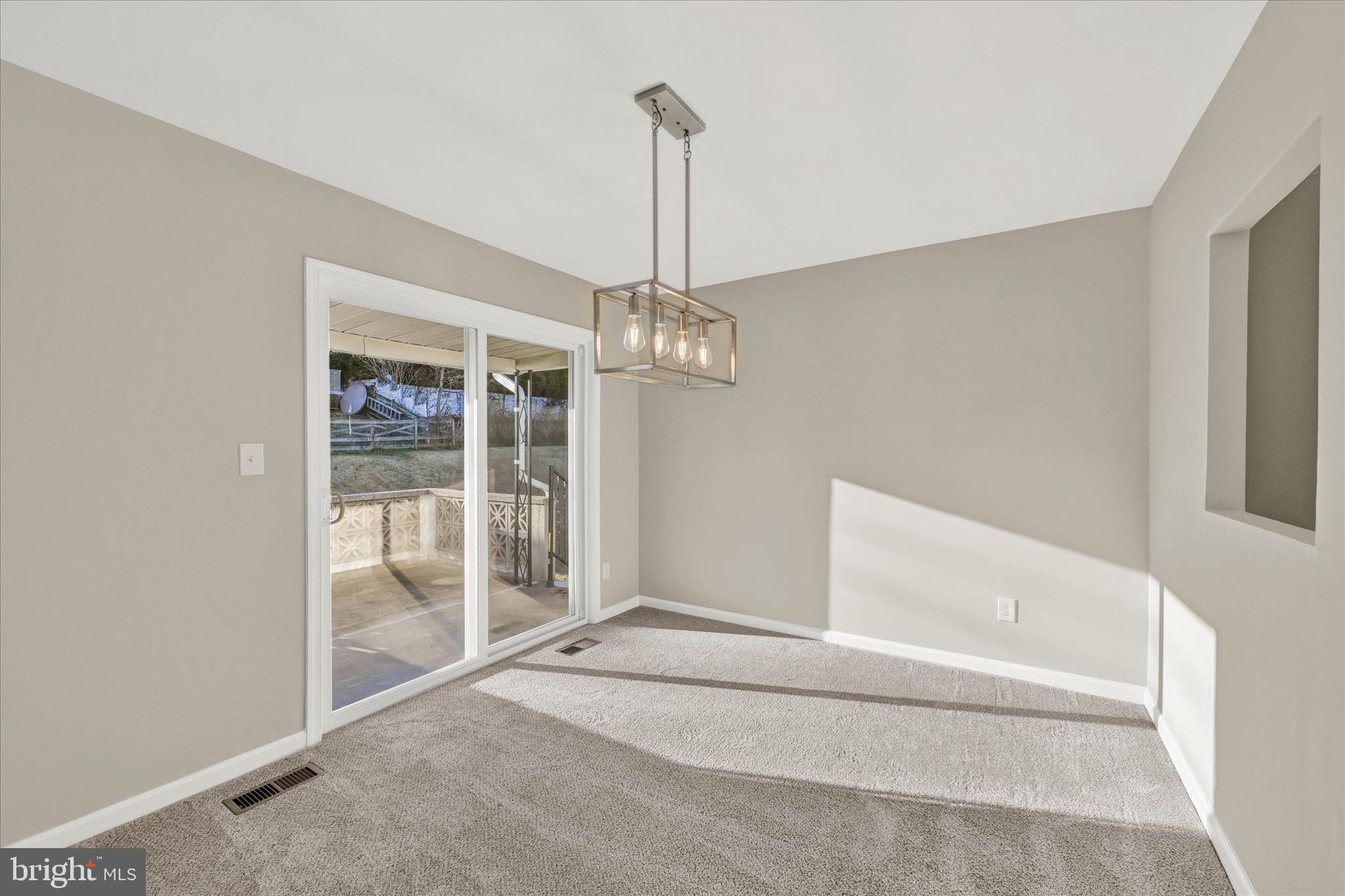 8117 Callo Lane Rosedale, MD 21237 - Photo 8 of 23 a view of an empty room with glass door