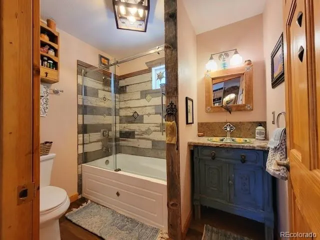 a bathroom with a sink toilet and shower