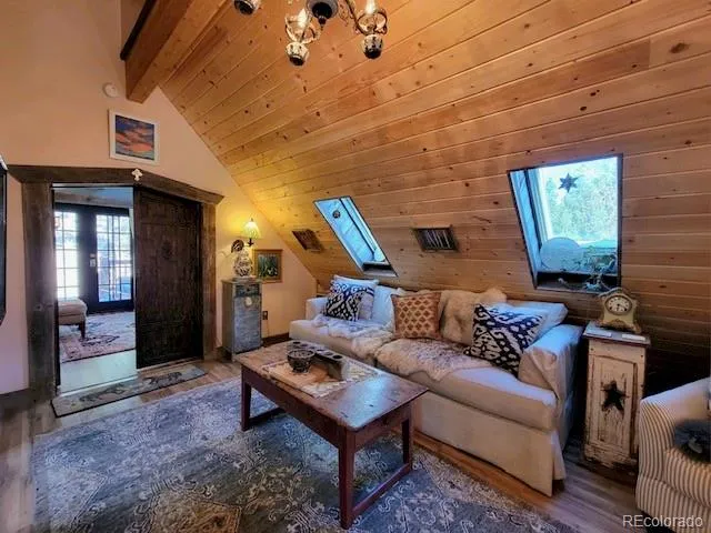 a living room with furniture a rug and a window