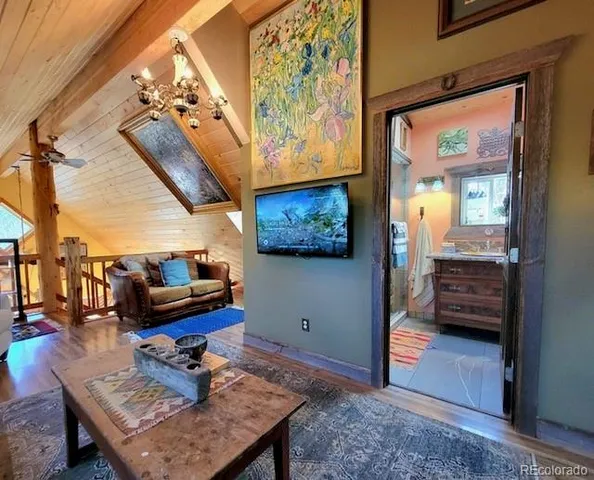 a living room with furniture and a chandelier