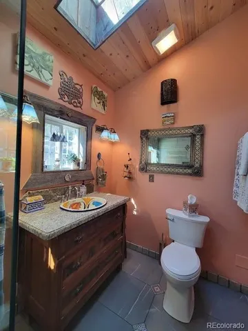 a bathroom with a toilet sink and mirror