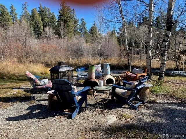 a view of a patio with table and chairs and couches