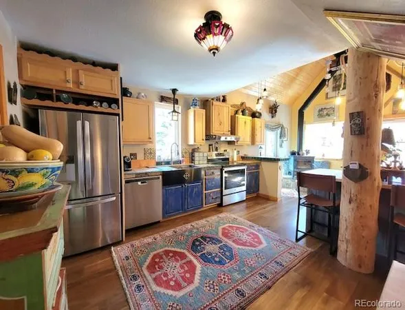 a kitchen with stainless steel appliances granite countertop a refrigerator and a stove