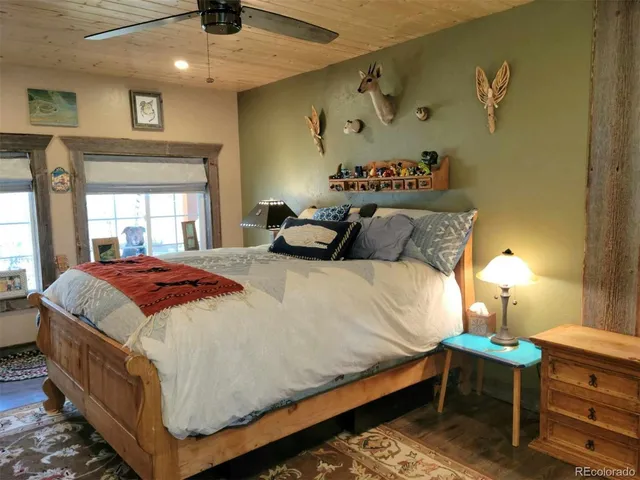 a bedroom with a bed and a lamp on dresser